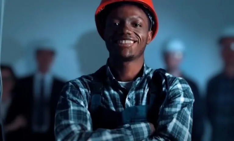Construction worker in a plaid shirt and hard hat