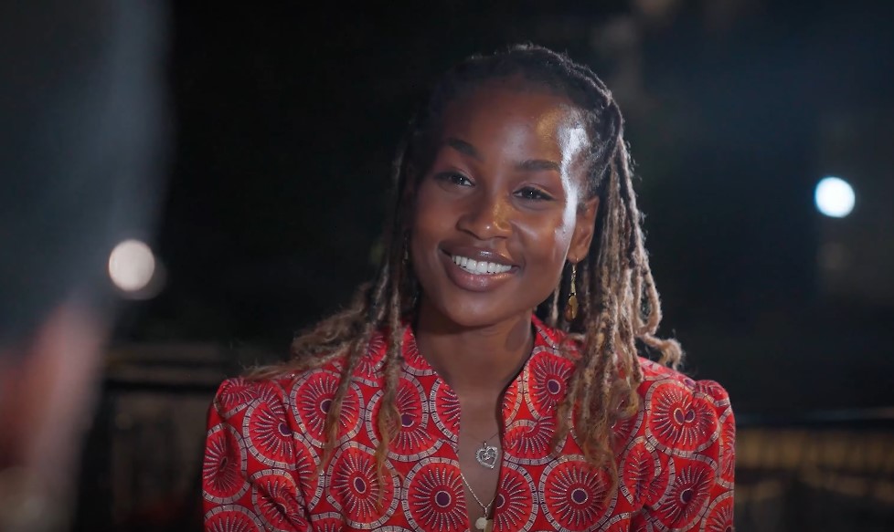 Close-up of a woman with dreadlocks, radiating confidence and positivity