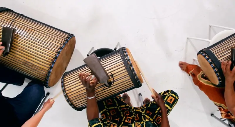 Group of people playing <yoastmarkhttps://organology.net/instrument/dunun/