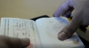 A passport, open to reveal official visa stamps
