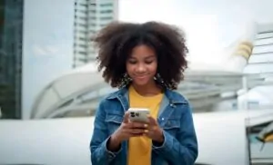Close-up view of a person using a smartphone outdoors