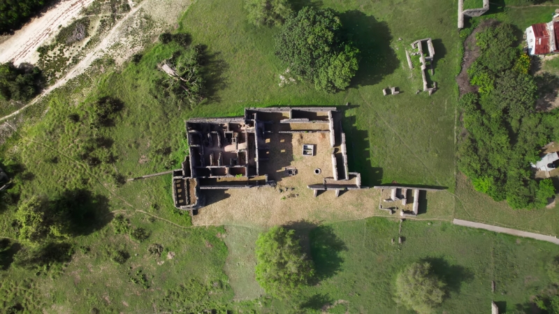 Aerial view of ancient stone ruins surrounded by greenery, linked to lost African kingdoms