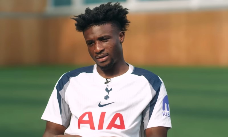 Kudus gives an interview on a training pitch, wearing Tottenham jersey