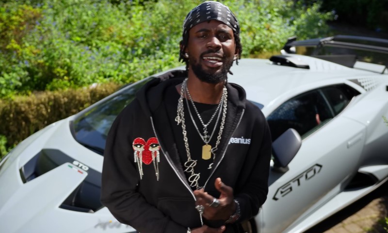 Black Sherif raping in front of a white luxury car