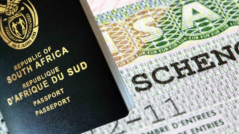 South African passport placed next to a Schengen visa page