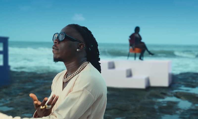 Stonebwoy singing on the beach in a music video