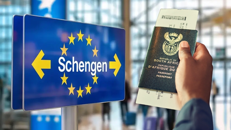 South African passport held near a Schengen sign at an airport checkpoint
